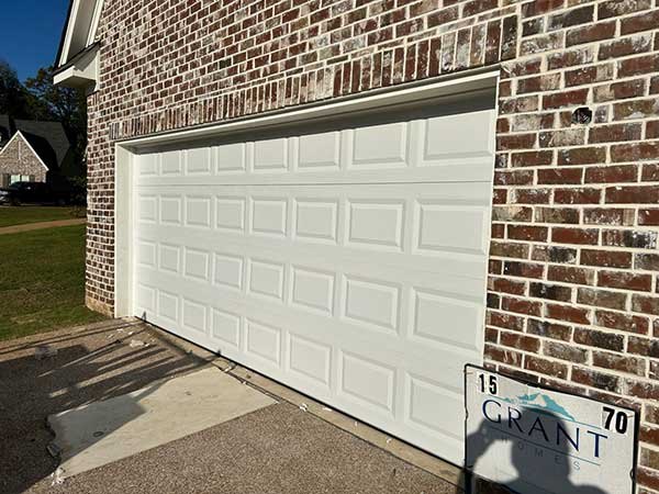 Raised-panel garage door on a brick home