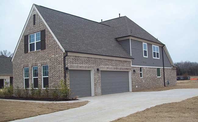 Two-car garage doors on a new brick home