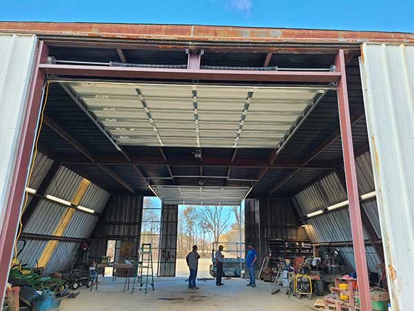 Large commercial overhead door opening on a steel building