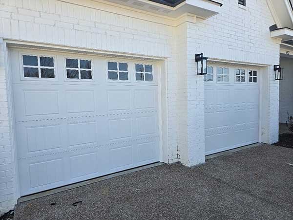 Pair of white garage doors with window inserts