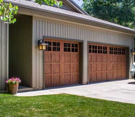 Pair of stained wood carriage-style garage doors installed by A-1 Door Co.